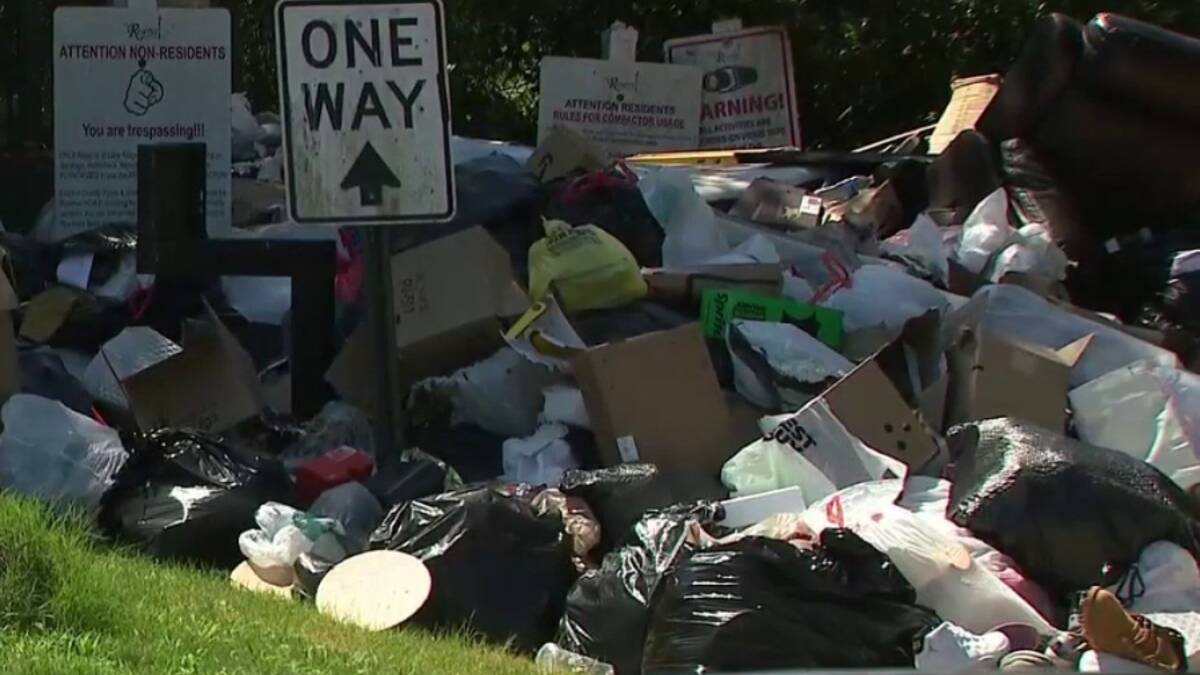 A broken trash compactor has left one Georgia neighborhood piled under garbage