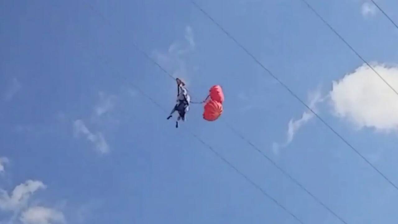 Terrifying moment zipline thrillseeker is STRANDED 150ft up as high wind stops her ride leaving her flailing in panic