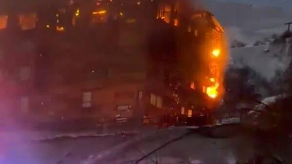 Horrifying moment hotel at ski resort goes up in flames as 150 terrified guests flee to escape raging inferno